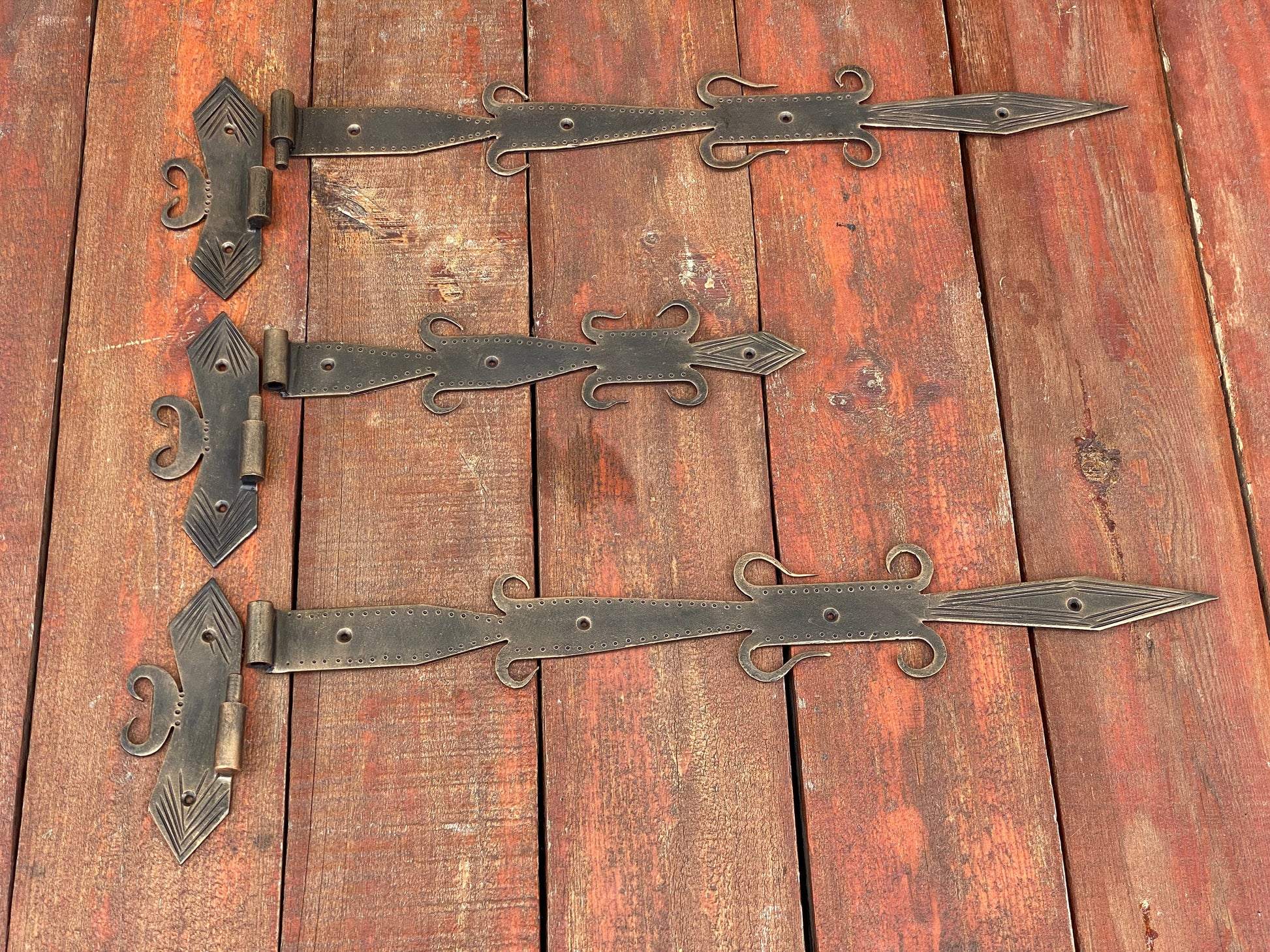 Large Metal Decorative Hinges On A Weathered Wooden Barn